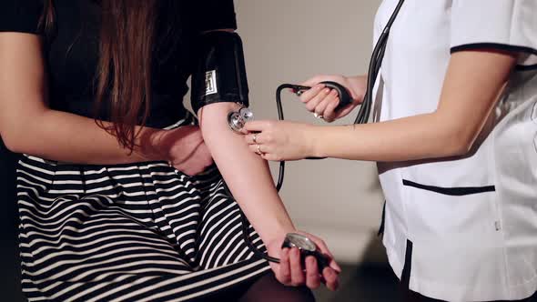 Doctor checking woman blood pressure. Concept of health, medicine.