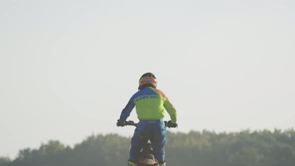 Motocross biker riding in the air
