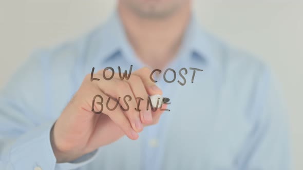 Low Cost Business, Man Writing on Transparent Glass Screen