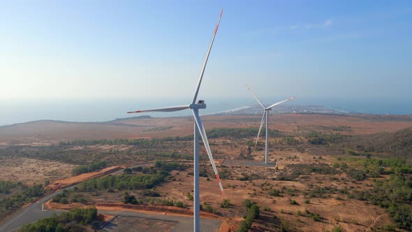 Aerial Shot of a Group of Wind Turbines in a Semidesert Environment