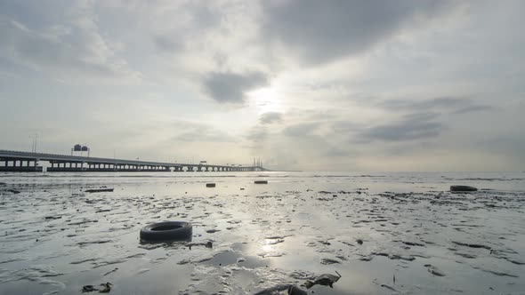 Timelapse morning sunrise over dirty sea coastal.