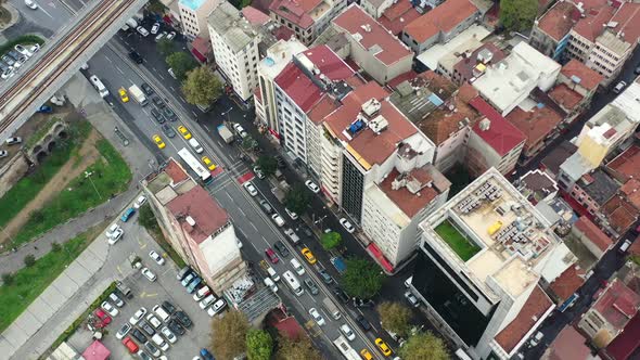 Aerial top down view of busses and taxis in traffic surrounded by old European residential buildings