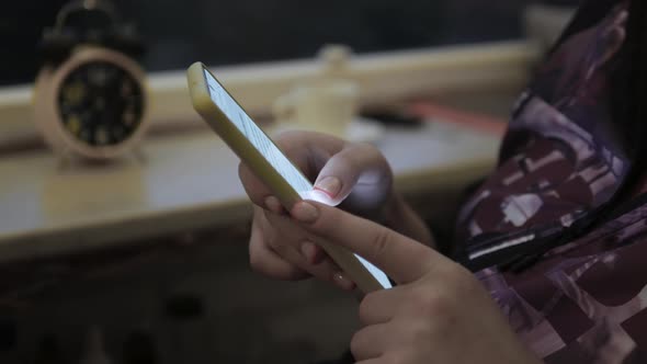 Female Hands With Beautiful Manicure Typing Text On The Smartphone Keyboard. Use Your Smartphone