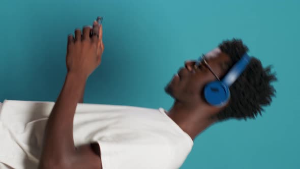 African American Man Using Headphones and Smartphone