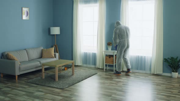 Man in Protective Clothes Is Disinfecting Apartmen