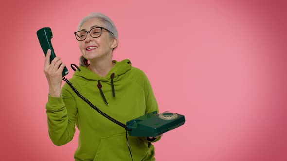 Crazy Elderly Granny Old Woman Talking on Wired Vintage Telephone of 80s Fooling Making Silly Faces