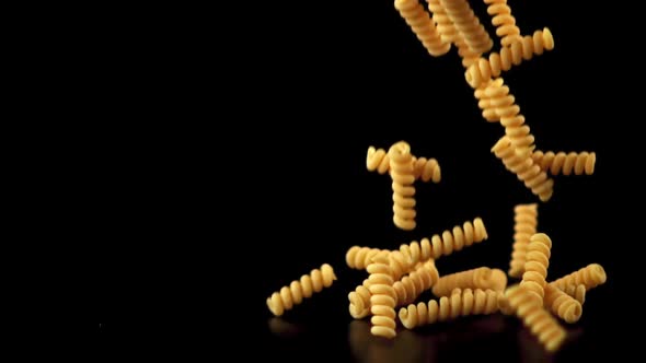 Super Slow Motion Dry Fusilli Pasta Falls on the Table