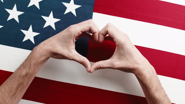 Hand in Heart Shape on American Flag