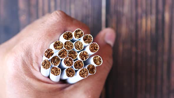 Holding Many Cigarettes on Table Close Up