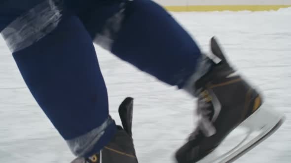 Low Section of Ice Hockey Players Dribbling