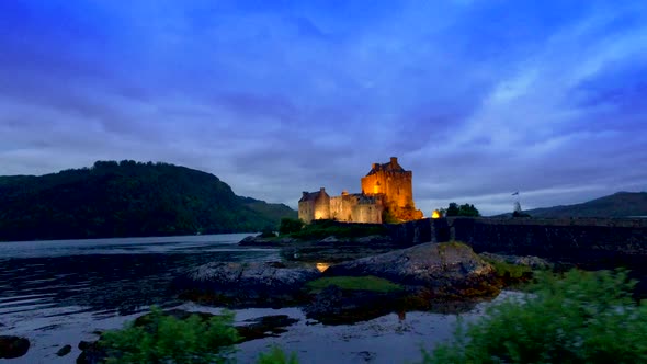 Beautiful dusk at illuminated Eilean Donan Castle over the lake in Scotland