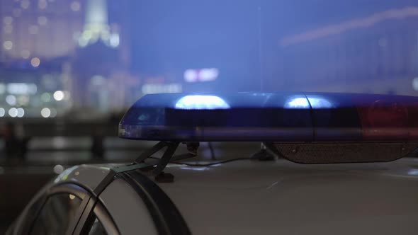 Flashing Flasher on the Roof of a Police Car at Night. Blinker.