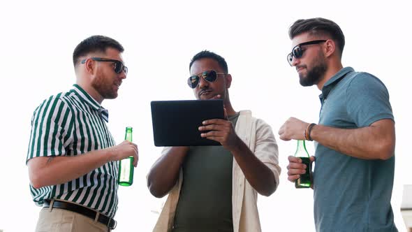 Men with Tablet Pc Drinking Beer on Rooftop