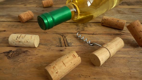 Wine bottles on an old vintage wooden board and falling corks