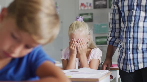 Video of african american male teacher supporting sad caucasian girl