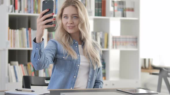 Young Woman Taking Selfie with Smartphone Photograph