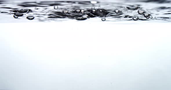 Water drips into a water surface - white background