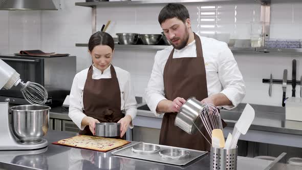 Woman and a Man Confectioners Prepare Berry Filling for Mousse Cake