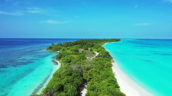 Wide birds eye clean view of a white sandy paradise beach and aqua turquoise water background