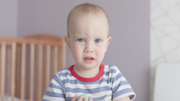 Cute Baby Boy Grimacing Funny Face Child Kid in Striped Blue Red Tshirt Nursery