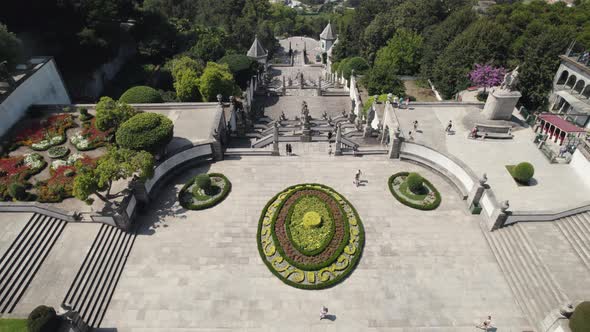 Aerial tilt up view Sanctuary Bom Jesus iconic Stairs with Braga Scenic Landscape