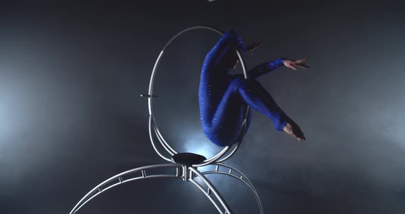 Beautiful Gymnastics Show in the Studio By a Young Woman in a Spinning Hoop