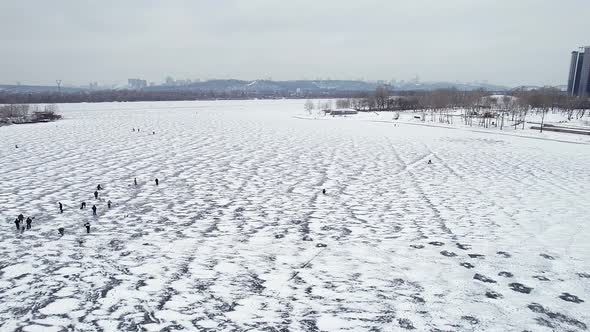 Fishermen Fishing in the Winter on the Ice of the Dnieper River in the City of Kyiv