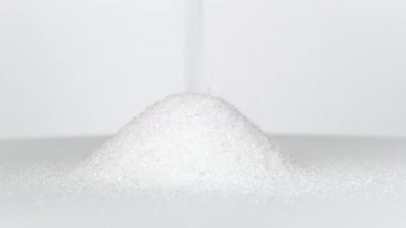 Sugar pouring onto white table