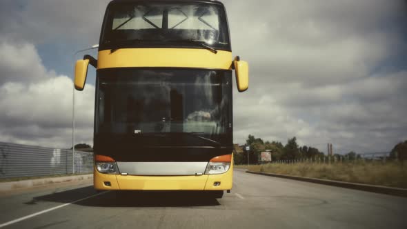 4k Yellow Bus driving on the road. Frontal cinematic shot of a Double-decker bus.