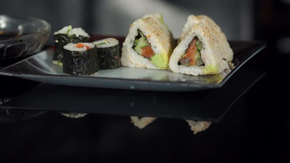 Chef Puts Ginger on the Sushi Plate Closeup