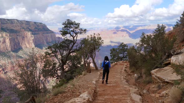 Girl walking on the hiking trail at Grand Canyon South Rim, Arizona, USA