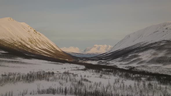 Aerial landscape of Lyngen Alps in Northern Norway. Snowy mountain valley