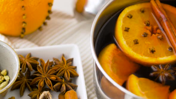 Spices and Hot Mulled Wine with Orange Slices 34