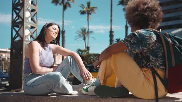 Two confident multiethnic women talking outdoors