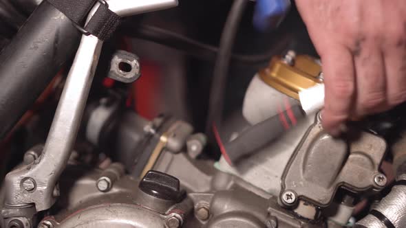 Mechanic Close Up Repairing Motorbike in Repair Garage