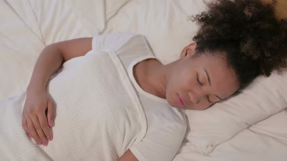 African Woman Sleeping in Bed Peacefully