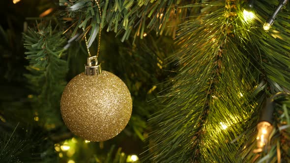 Close-up of golden color  Christmas ornament 4K 2160p 30fps UltraHD footage - Sparkling  gold bauble