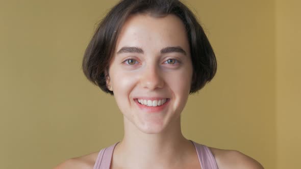 Portrait of young beautiful cute cheerful girl smiling looking at camera