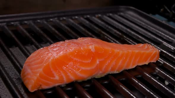 Closeup of a Delicious Piece of Raw Salmon Fillet Steak on the Grill