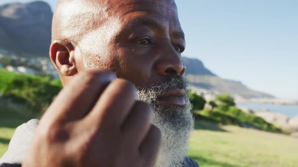 Senior african american man exercising putting earphones in