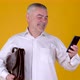 Portrait of Handsome adult businessman with briefcase uses smartphone texting messages - VideoHive Item for Sale