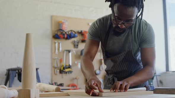 Carpenter marking with pencil on wood