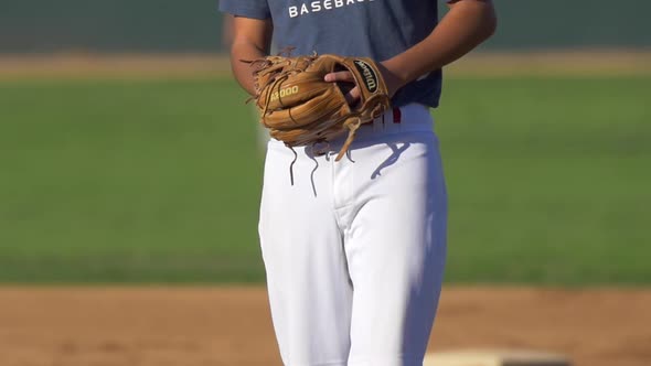 The pitcher at a baseball game throws the ball to the batter.