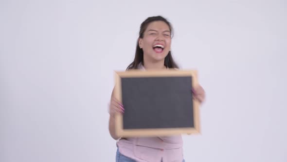 Young Happy Asian Businesswoman Holding Blackboard with Surprise