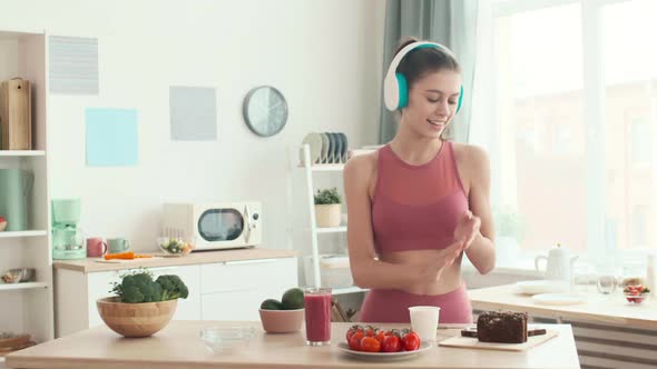 Cheerful Sportswoman Is Cooking Breakfast