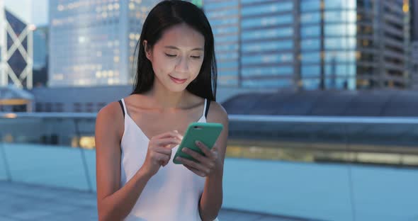 Woman use of smart phone in the city