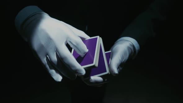 Close-up of a Suited Magician's Hands Performing Sleight of Hand Card Tricks, Slow Motion