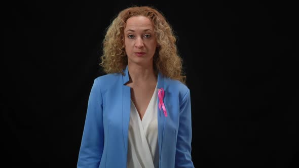 Caucasian Serious Woman Talking Raising Cancer Awareness Placard Looking at Camera