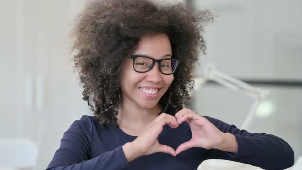 Portrait of African Woman Making Heart Shape By Hands