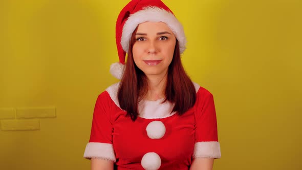 Woman in Santa Costume on Yellow Background